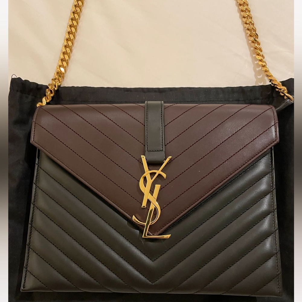 YSL two tone black and burgundy bag with flap closure and gold hardware